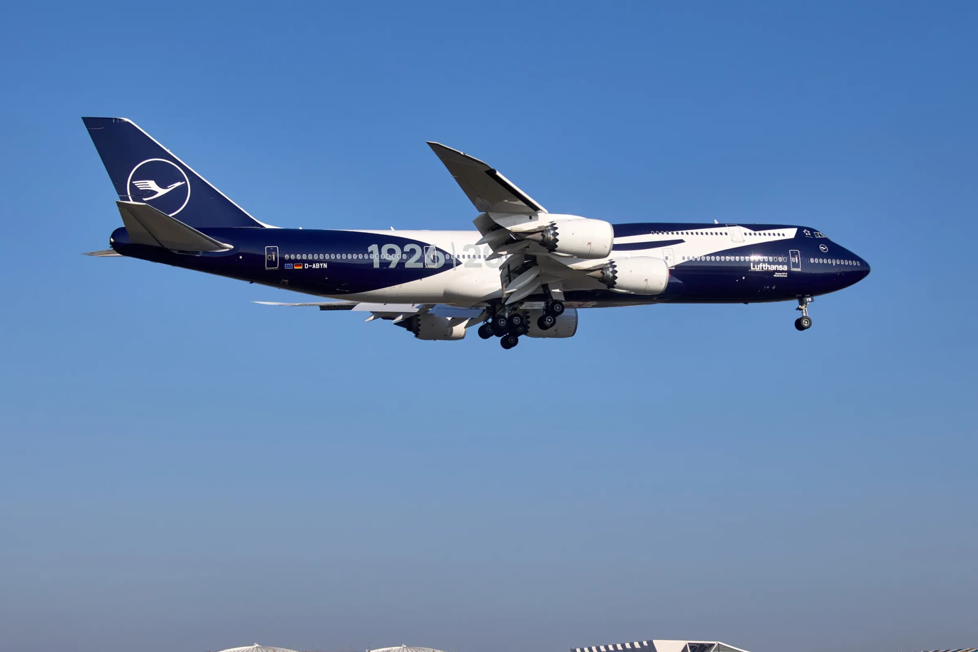 Lufthansa Boeing 747-8 in Jubiläumslackierung im Landeanflug vor blauem Himmel